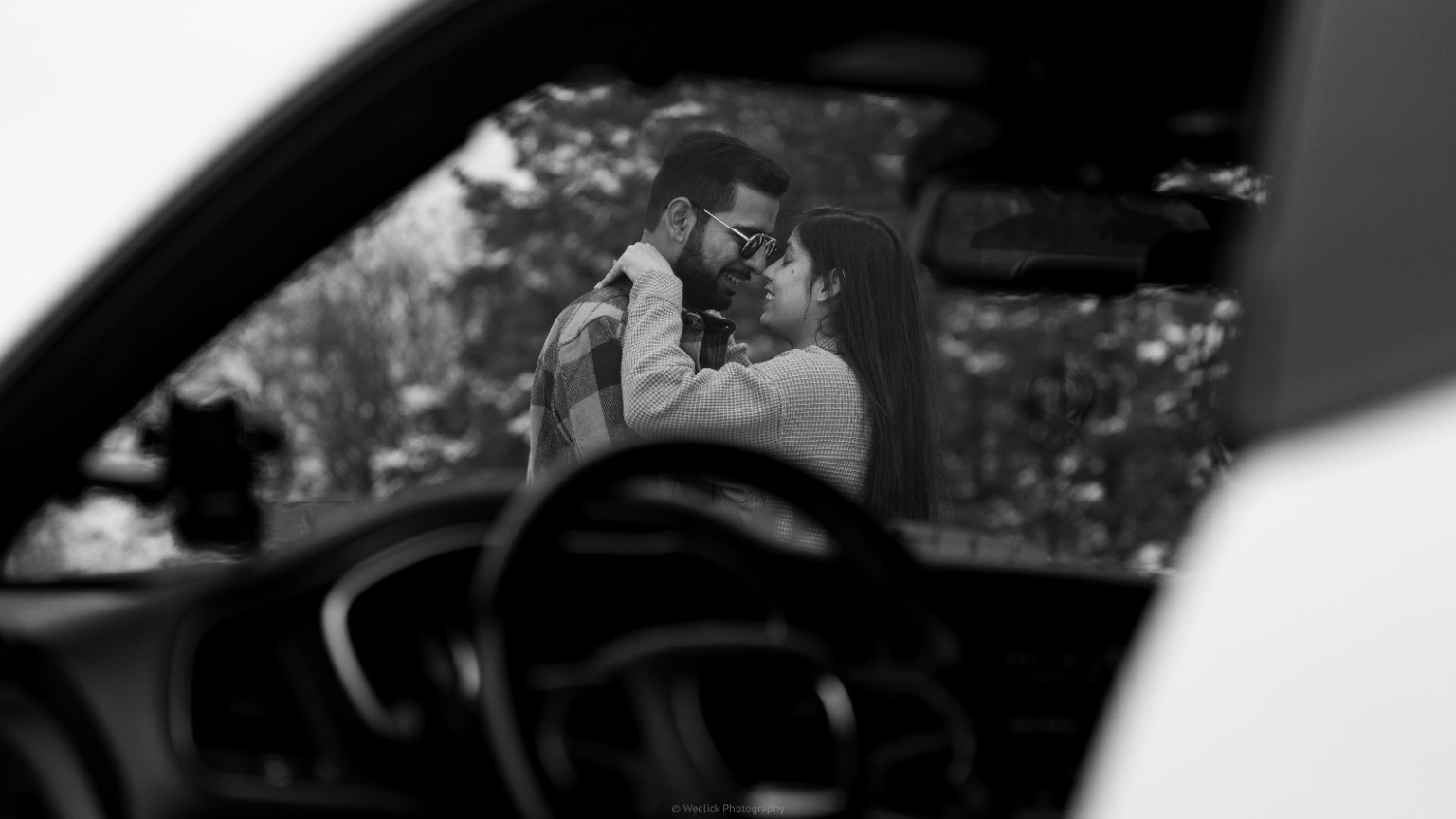 Black and white couple portrait photographed through a car